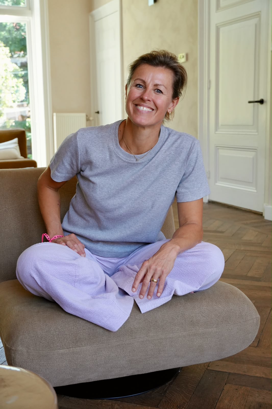 Esther van Diepen sitting cross legged at home